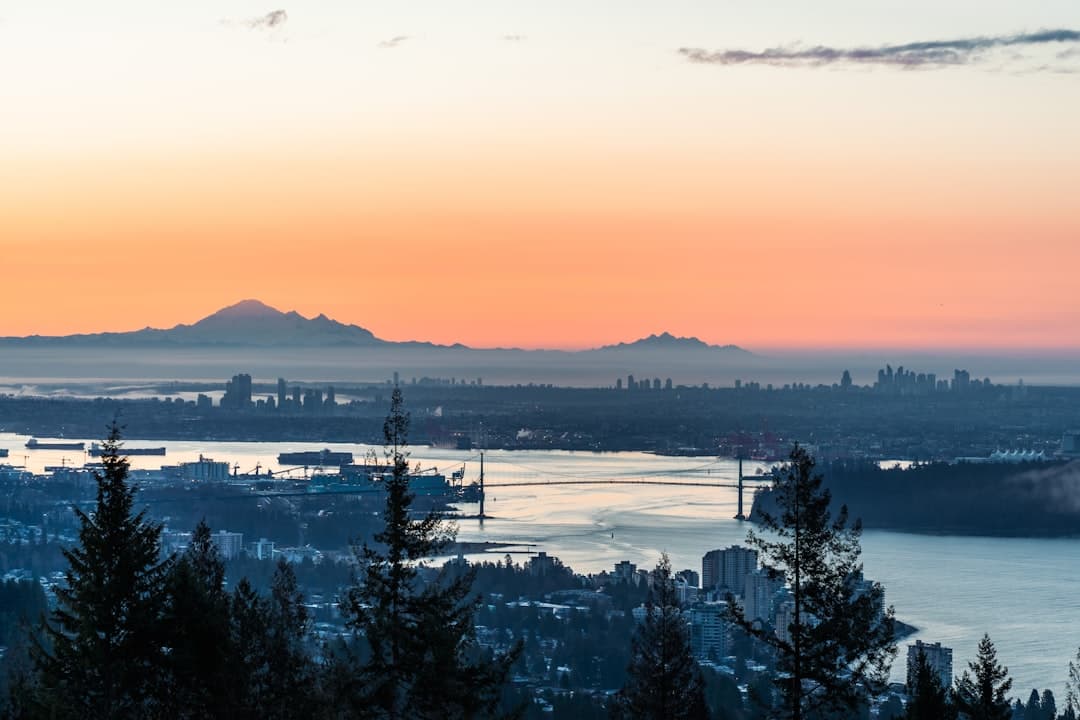 A construction crane against the Vancouver skyline at morning.